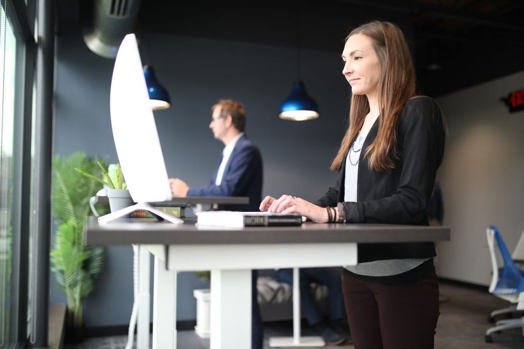 Woman working at a standing desk in an office