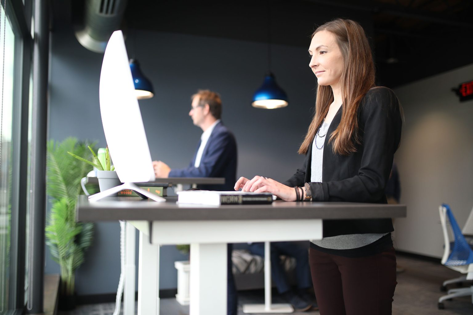 Woman working at a standing desk in an office