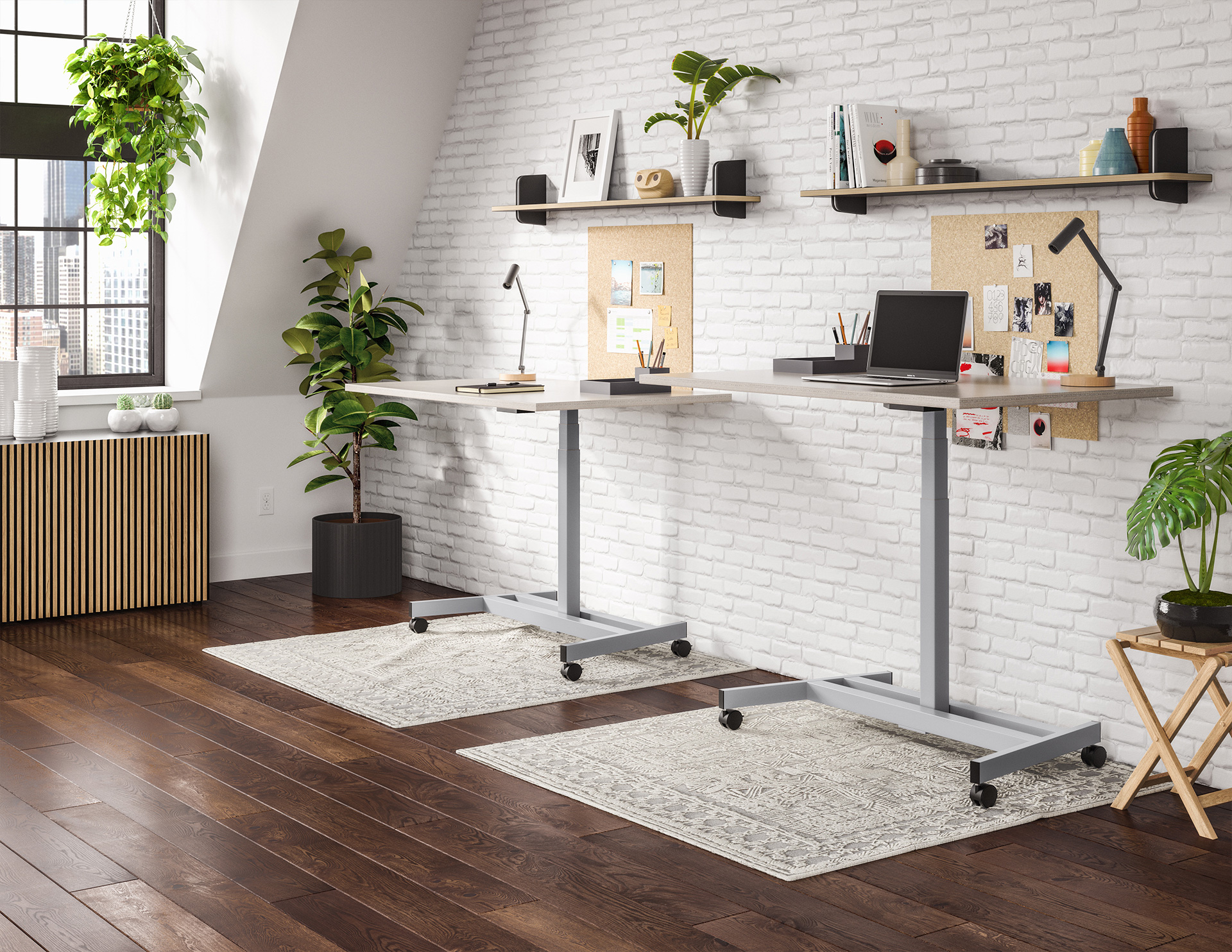 Two Ändern desks in a furnished workspace, showing their single center columns and open floor space