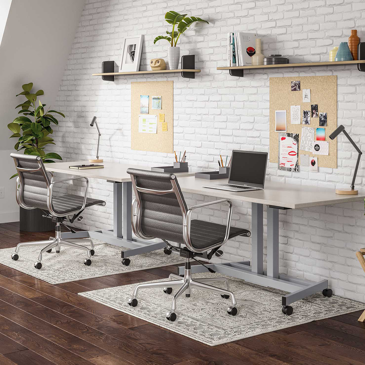 Two silver Lüften standing desks in a bright shared office