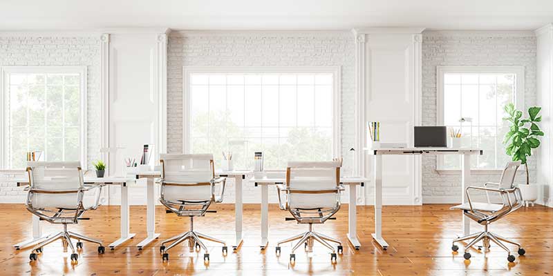 White Klöud standing desks arranged in a bright shared office