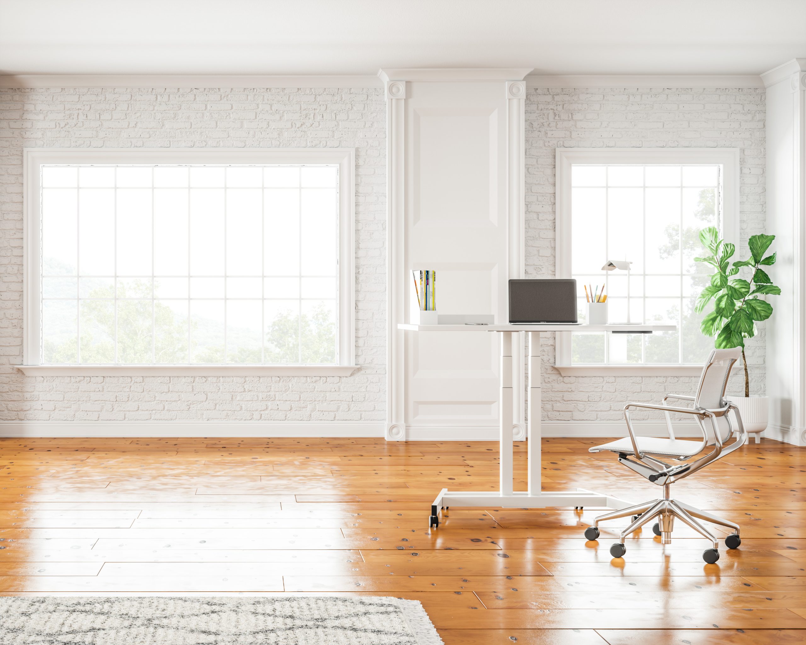 White Lüften standing desk at standing height in a bright room