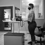 Person standing at a Nimbus desk in an office